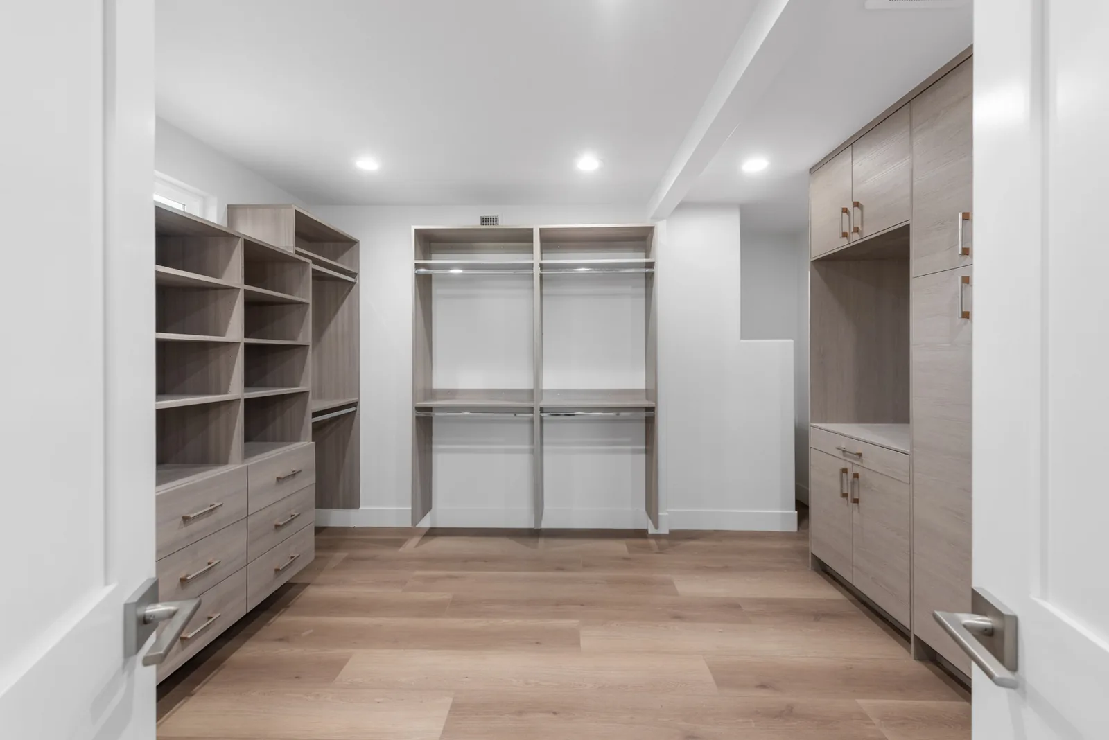 Closet Millwork: Walk-in closet with full built-in millwork, adjustable shelving and integrated lighting.