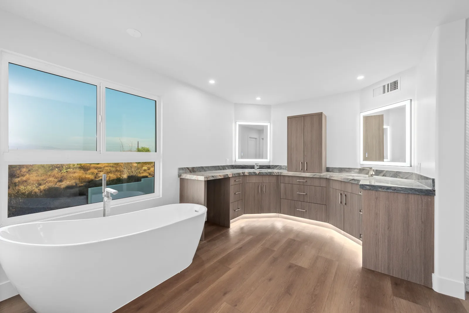 Curved Island Kitchen: Radiused waterfall island in quartz with rift-cut walnut and a fully integrated appliance package.