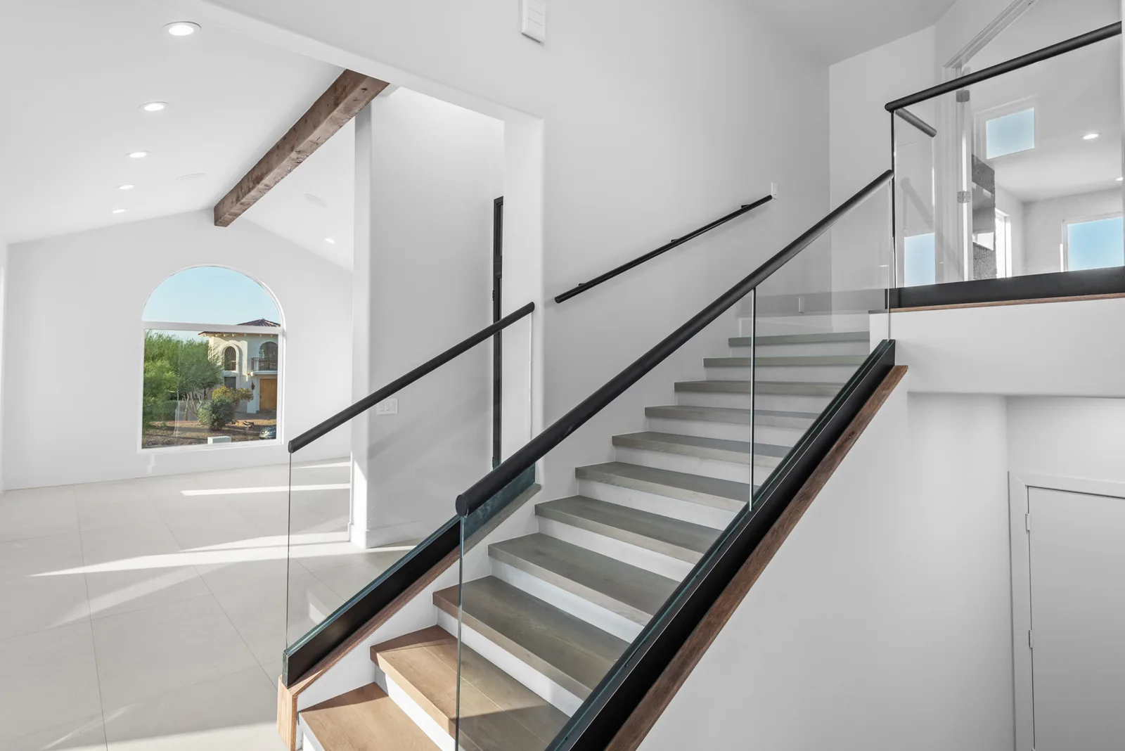 Floating Stair & Glass Rail: Cantilevered treads with a structural glass guardrail. Engineering, framing and finish coordinated in-house.