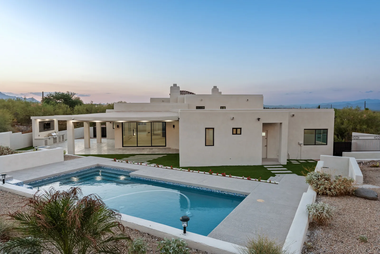 Pool & Turf Courtyard: Rear courtyard with pool, banded turf runners and a full masonry privacy wall. Grading, trenching and hardscape self-performed.