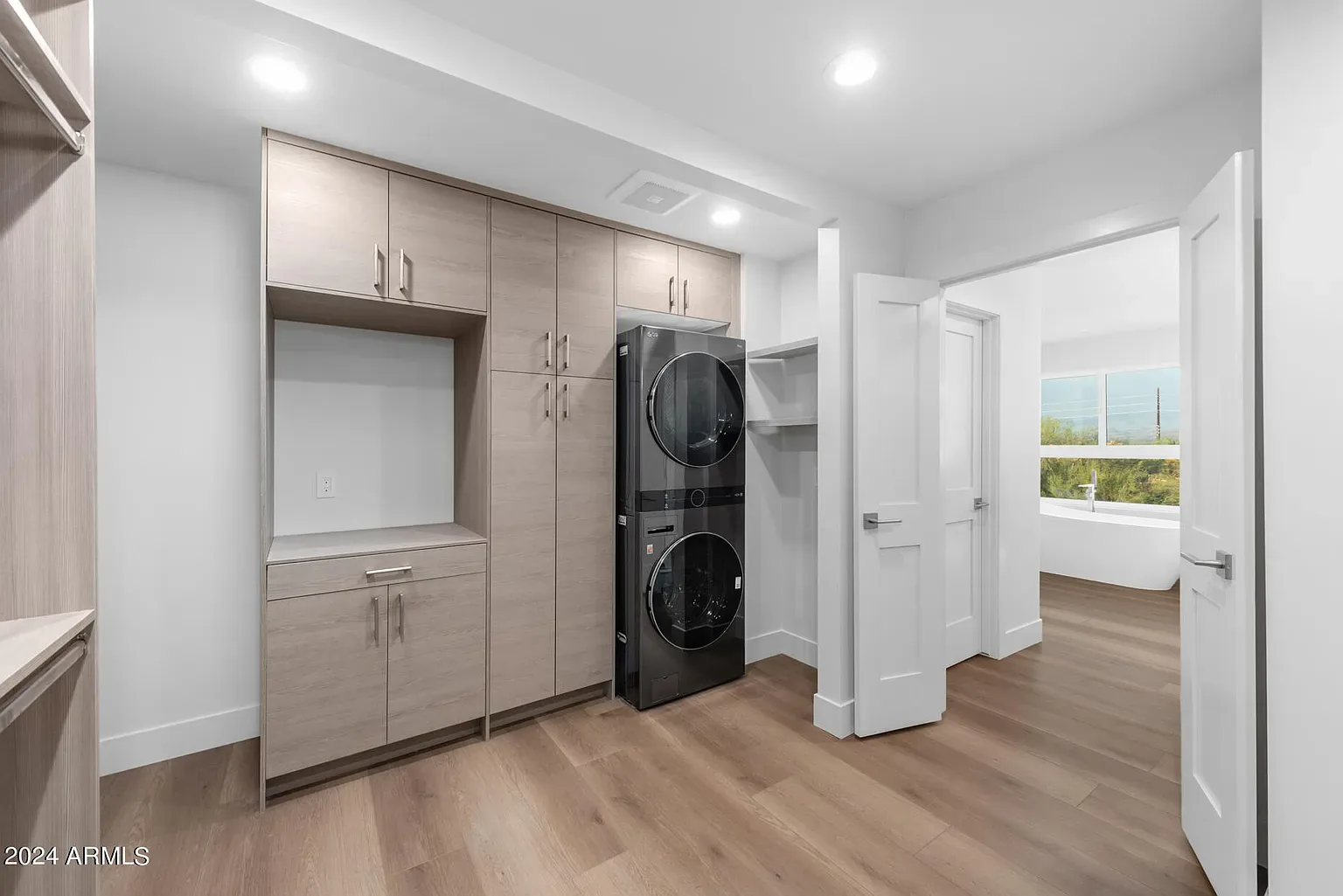 Utility & Laundry: Stacked laundry with floor-to-ceiling storage and a dedicated utility run, with code-compliant venting and power.